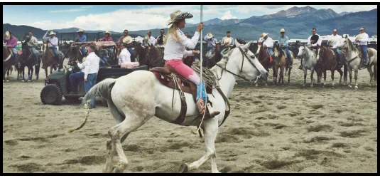 Photo of a person riding a horse with other contestants in the background.